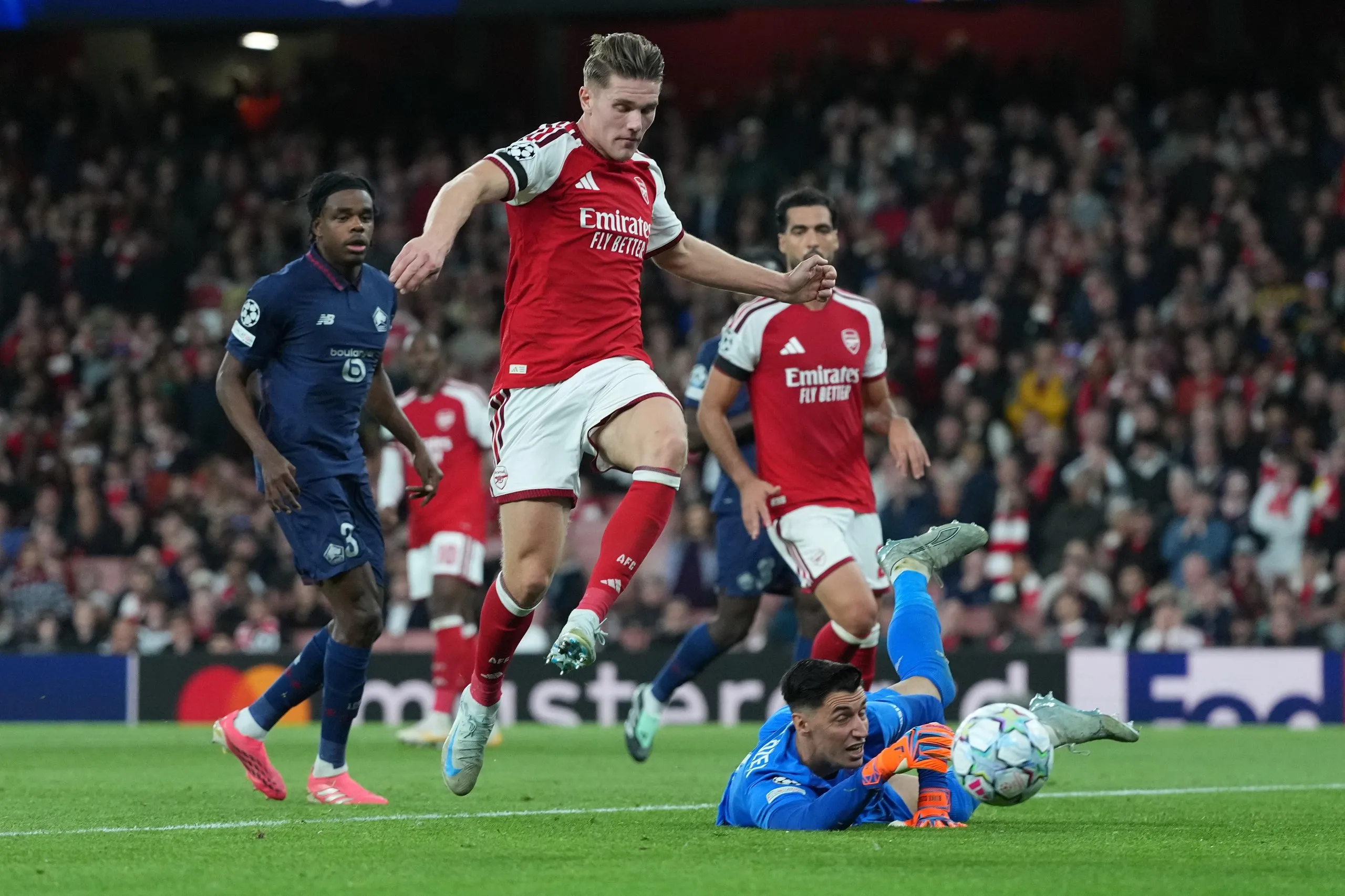 Lille's goalkeeper Berke Ozer saves in front of Arsenal's Viktor Gyokeres.