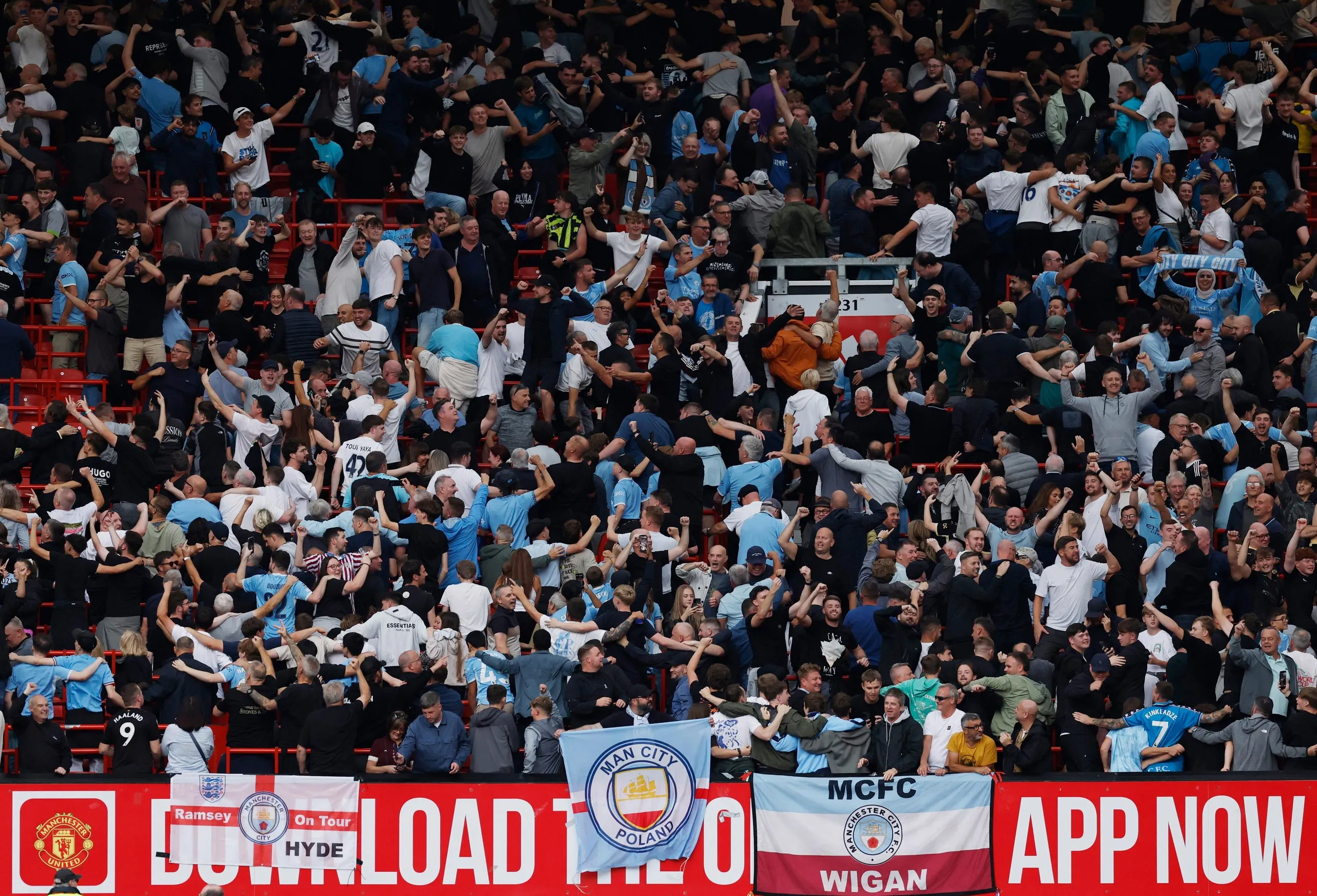 Manchester City fans celebrate after the match at Manchester United in September