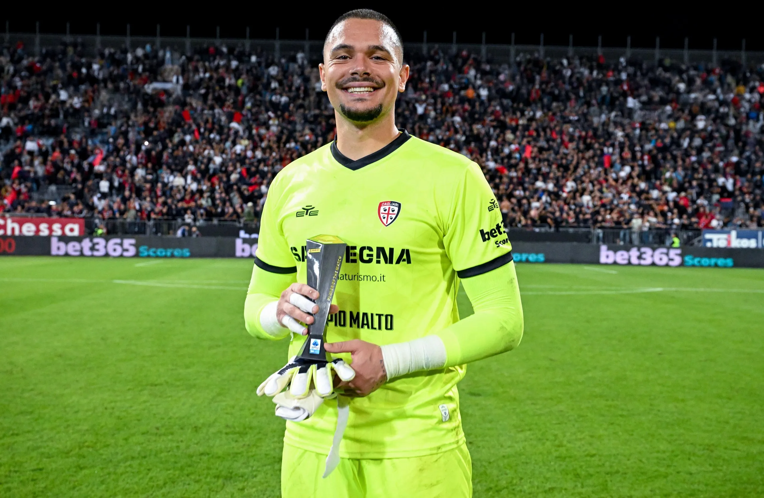 Elia Caprile poses with the player of the match award after the Serie A match between Cagliari and Juventus